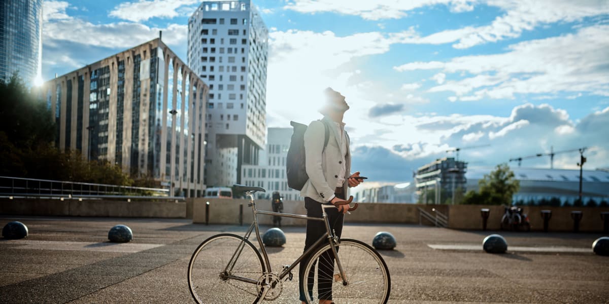 Resident walking his bike around downtown on a beautiful day near Brooklyn Yard in Portland, Oregon