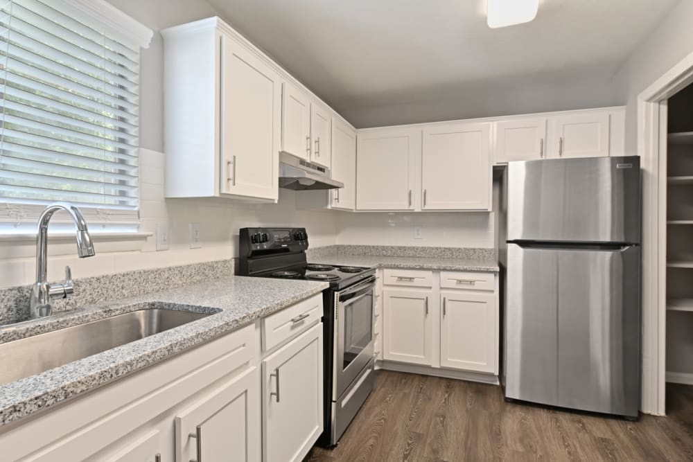 Hardwood flooring and a stainless-steel appliances in a model apartment's kitchen at Crest at Riverside in Roswell, Georgia