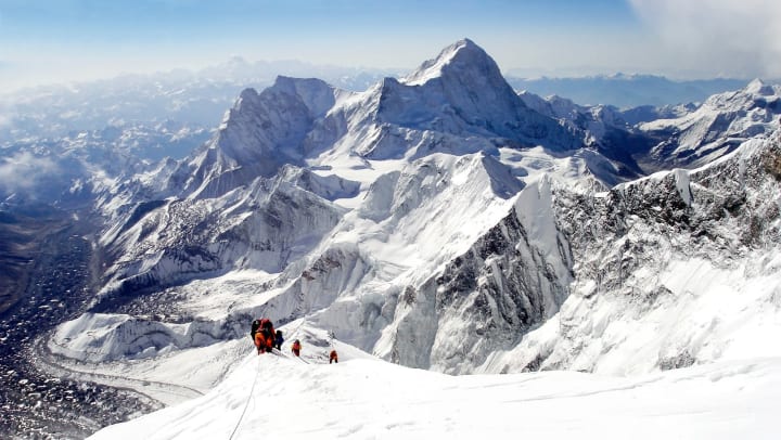 Climbers on a snowy mountain peak 