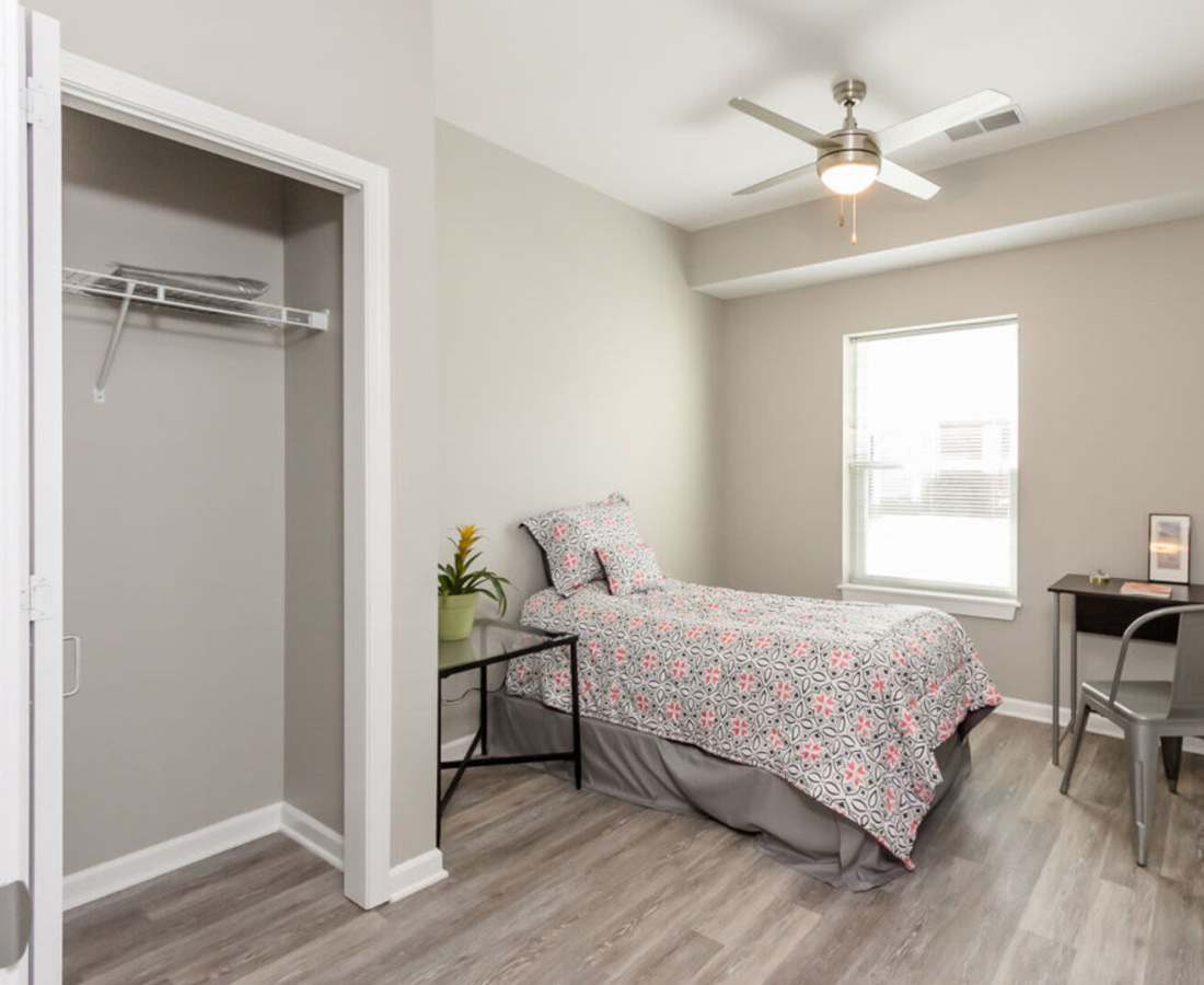 Bedroom with simple decor and window lighting at Eagle Ridge Circle in Rochester, New York