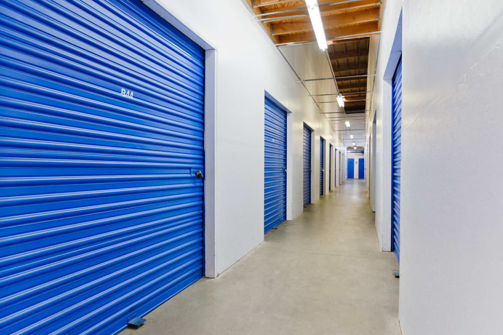 Indoor storage units with blue doors at A-American Self Storage in Santa Barbara, California