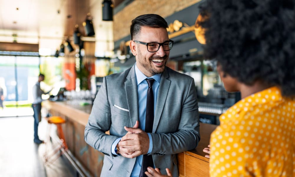 Resident meeting a client for coffee at his favorite café near Oaks 5th Street Crossing at City Station in Garland, Texas