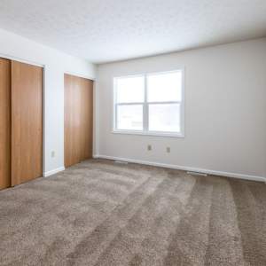 Unfurnished bedroom with carpet flooring at Unionville Station Townhomes in Hilton, New York