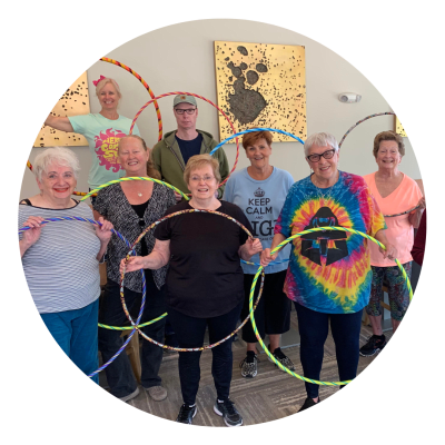 Residents holding hula-hoops after a fitness class at Sunstone Village in Denton, Texas.