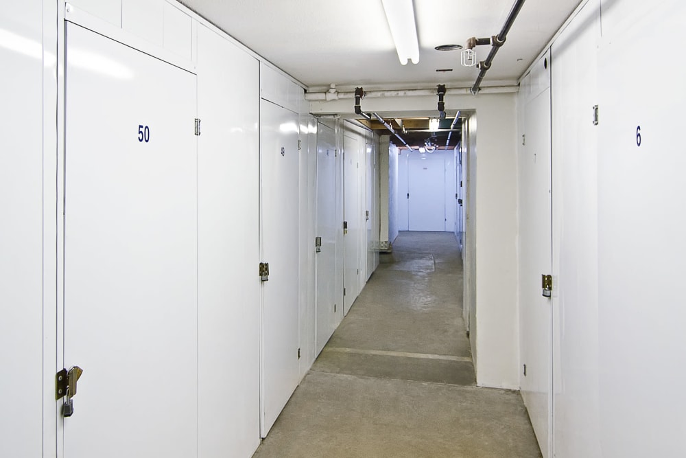 Locked storage units along a brightly lit hallway at A-American Self Storage in Santa Barbara, California