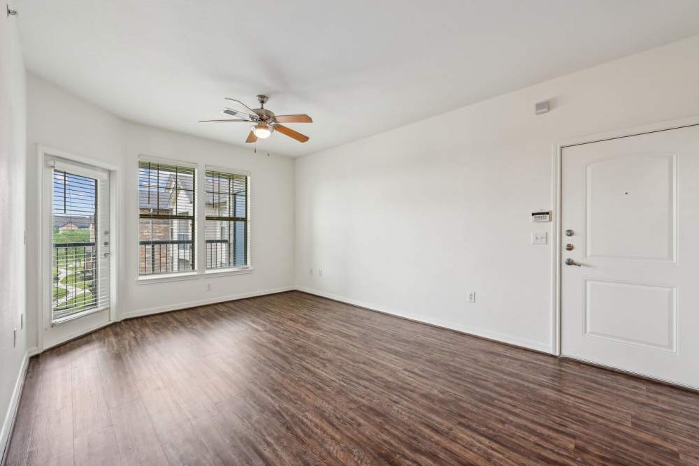 Well-lit bedroom with a large window and a ceiling fan at Barron Park in Pearland, Texas