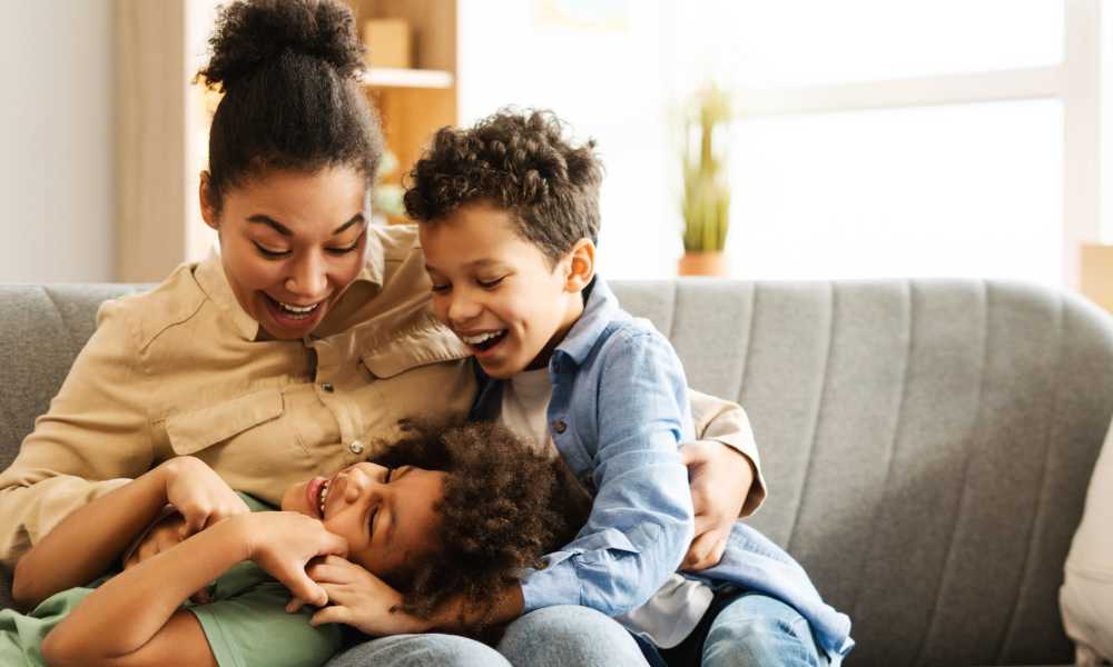 Happy family in the living room at Cherokee Summit Apartments in Acworth, Georgia