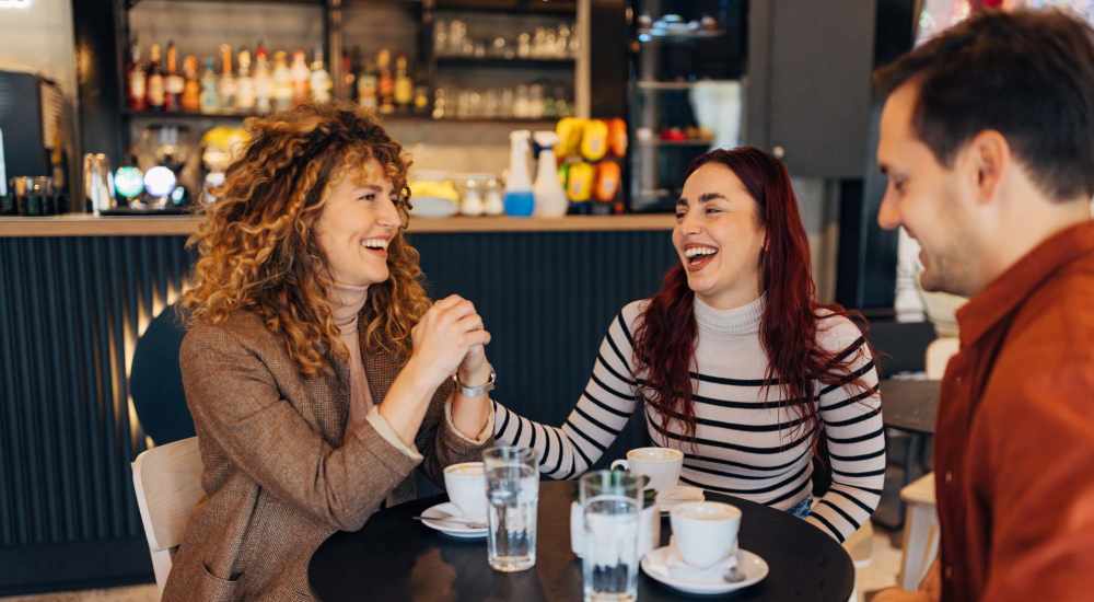 Friends are having coffee in a local coffee shop near Stone Creek Village Apartments in Charlottesville, Virginia
