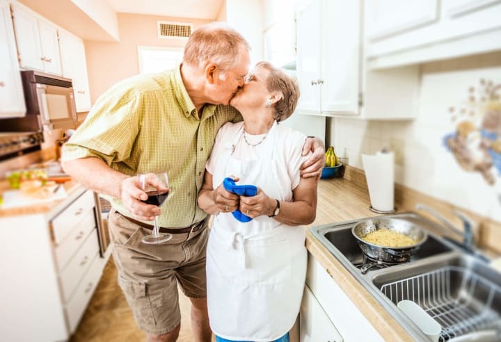Senior couple kissing in kitchen