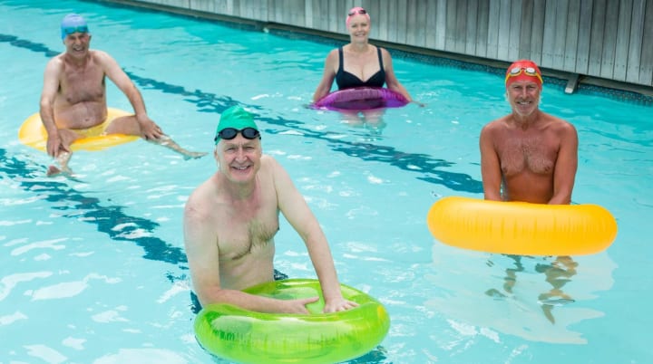 Seniors doing water aerobics together