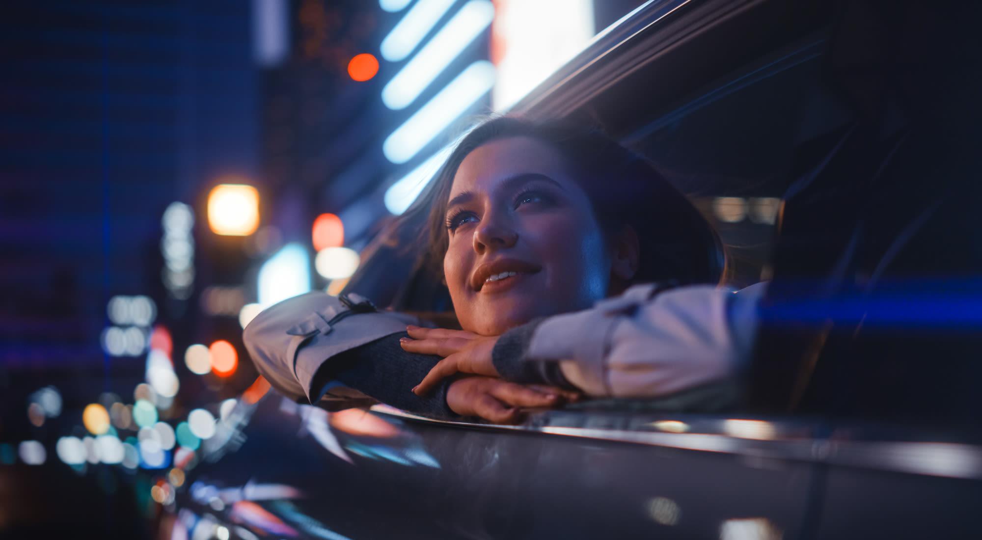 A woman leans out of a car at night in Granite Creek, Rocklin, California.