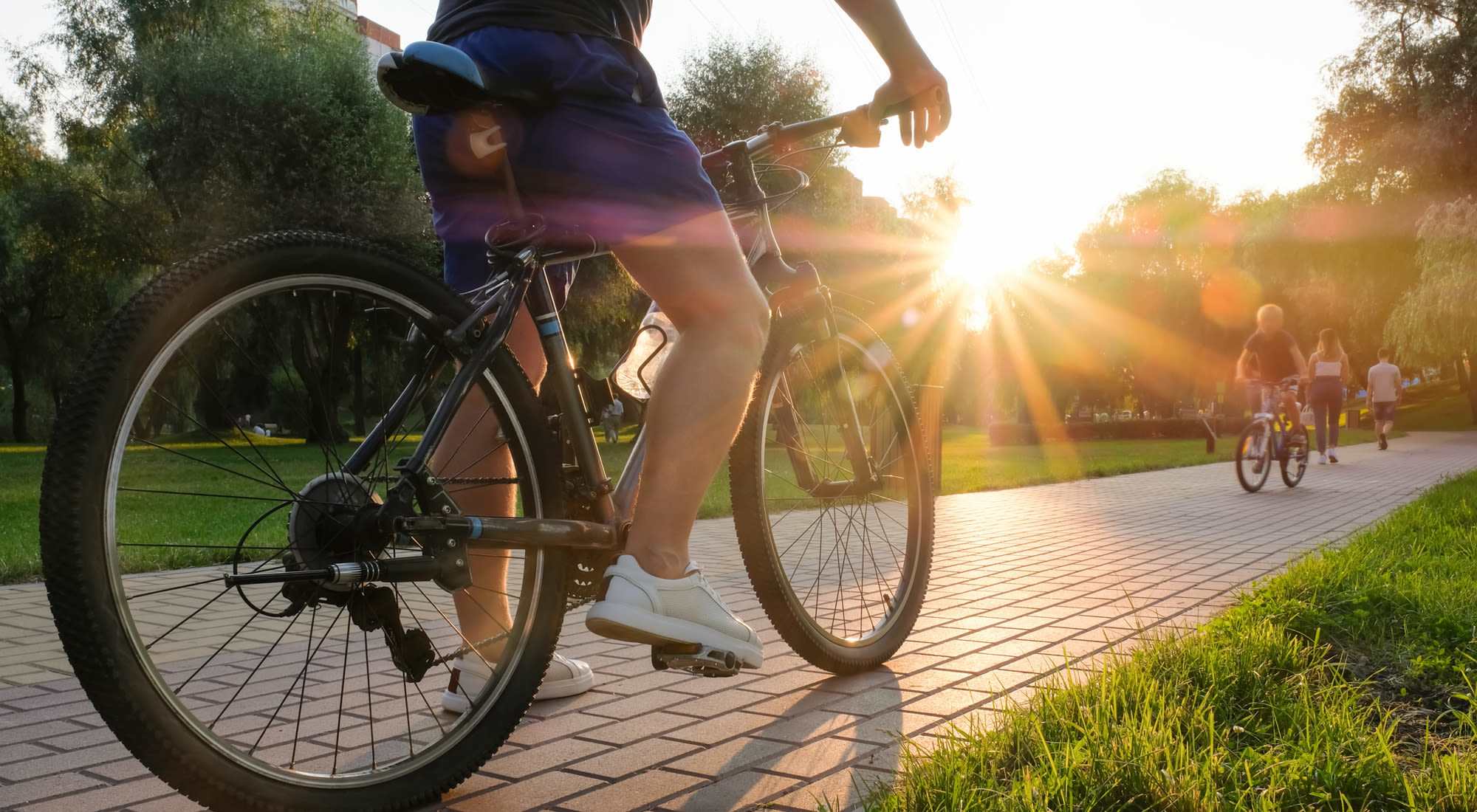 Residents biking and walking along a park near Baywoods in Antioch, California      