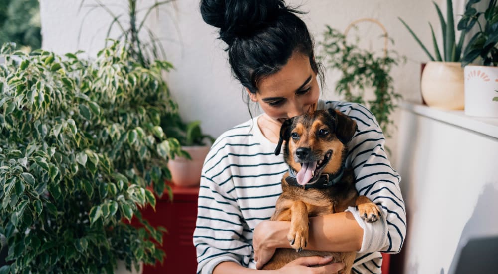 Resident holding her dog at Pepperwood in Davis, California