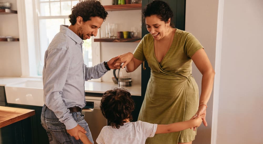 Family dancing in the kitchen at Courtyard Apartments in Stockton, California