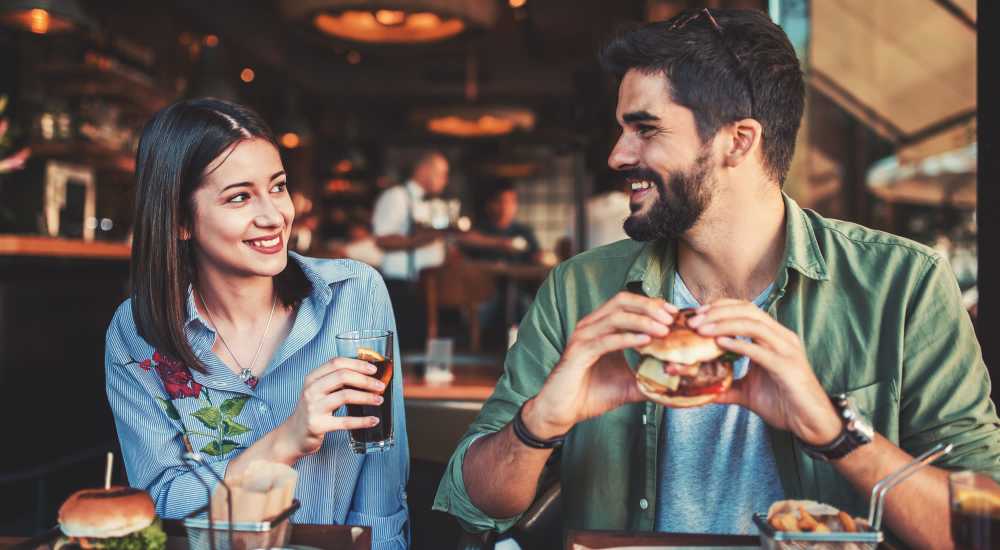 Happy couple eating in restaurant near The Residences at Barnett in Jacksonville, Florida