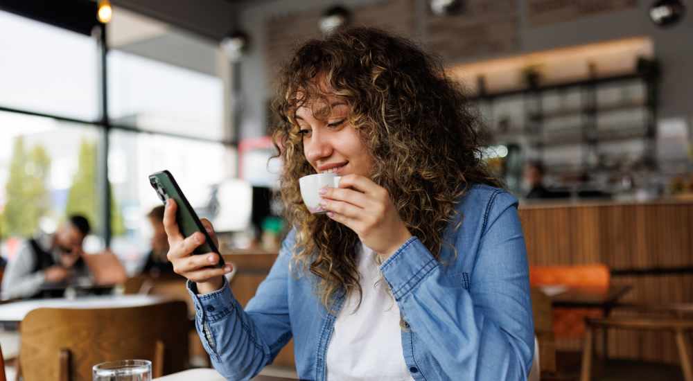 Woman having coffee at a cafe near Brookwood Apartments in Columbia, Tennessee
