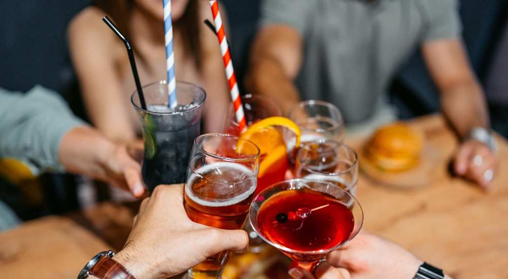 Friends enjoying drinks in party near Suncrest Apartments in Tumwater, Washington