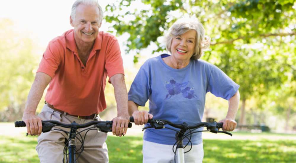 Resident couple cycling in a park near Commerce Senior in Los Angeles, California