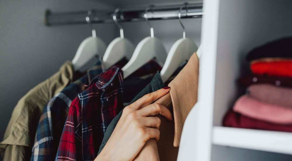 Elegant wardrobe with neatly arranged clothing items at Bellwood Gateway Apartments in Bellwood, Illinois 