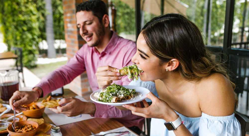 Resident couple having food at restaurant near Stonegate at the Crossroads in Zion Crossroads, Virginia