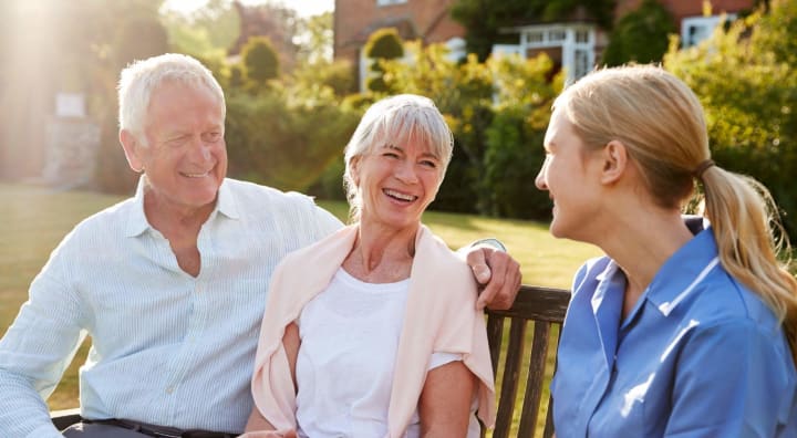 Senior couple smiling with nurse