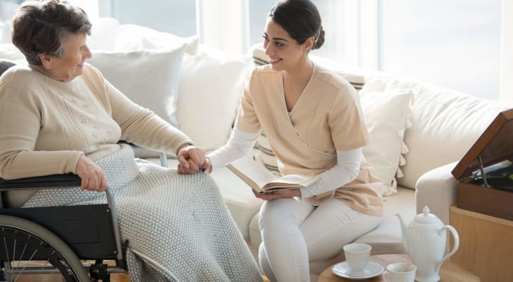 Senior woman in wheelchair with caregiver