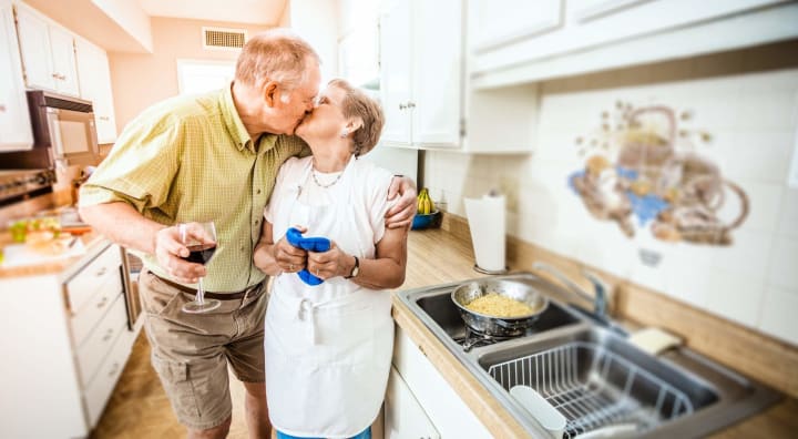 Senior couple kissing in kitchen