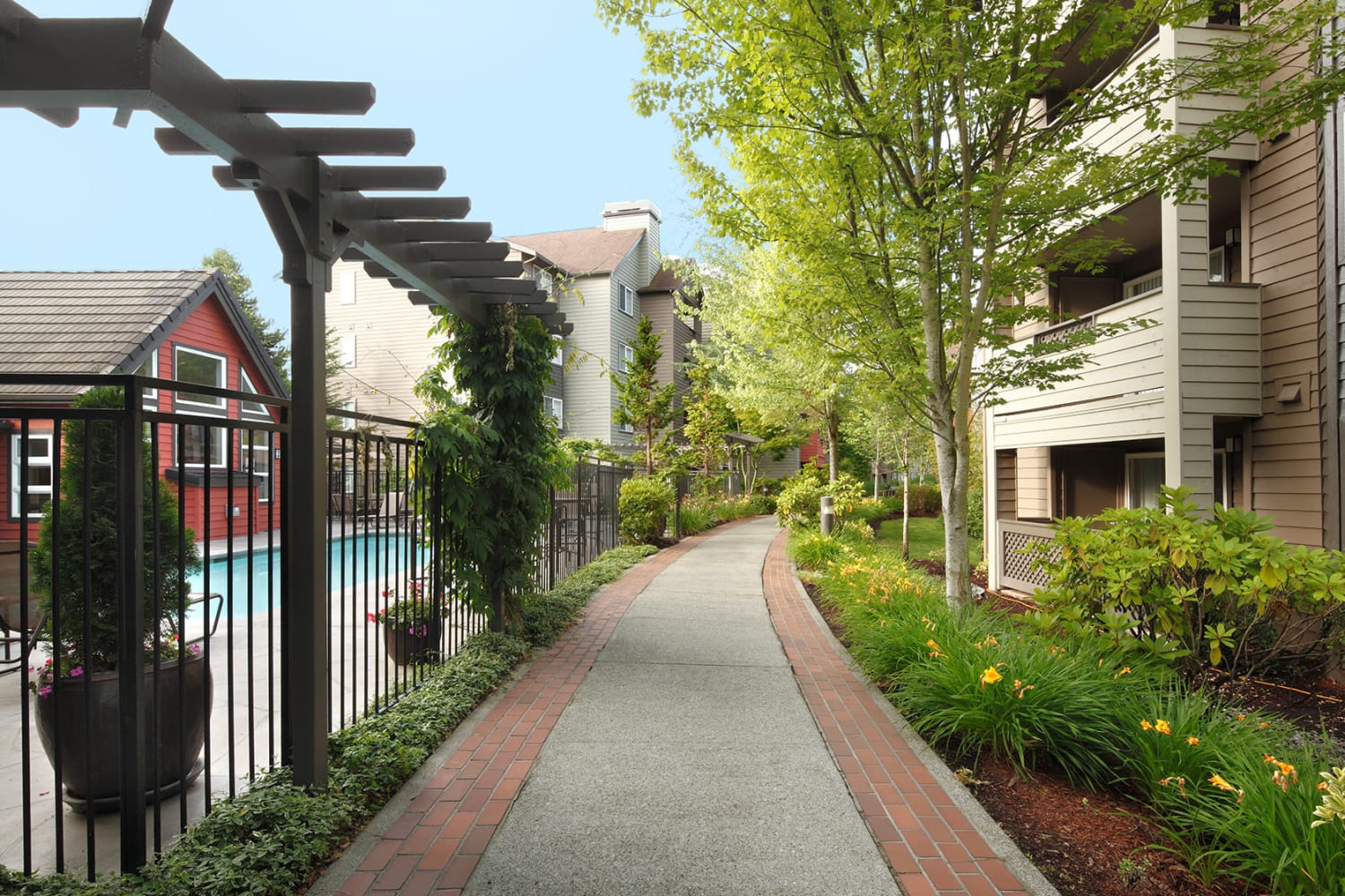 Walking path right next to the pool at Redmond Place Apartments in Redmond, Washington