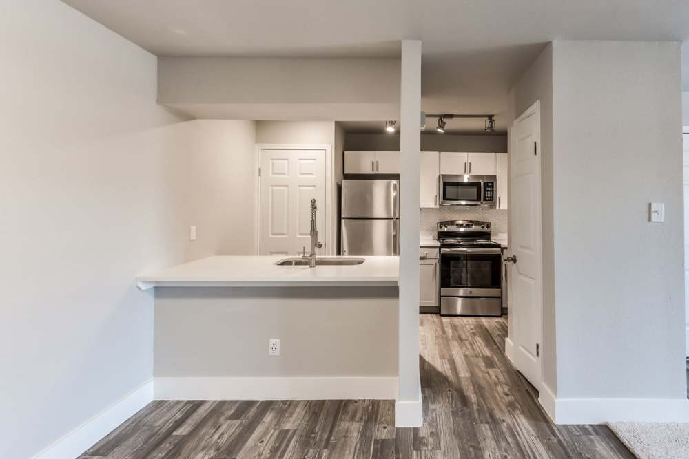 Kitchen with a range , steel appliances and stainless-steel sink at Warwick at Westchase in Houston, Texas