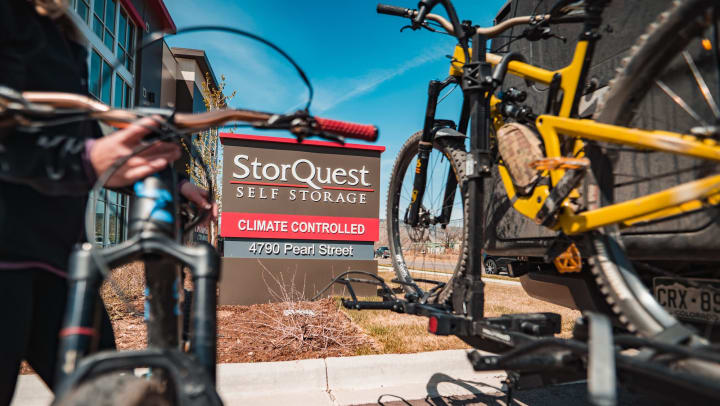 Two mountain bikes facing towards StorQuest signage