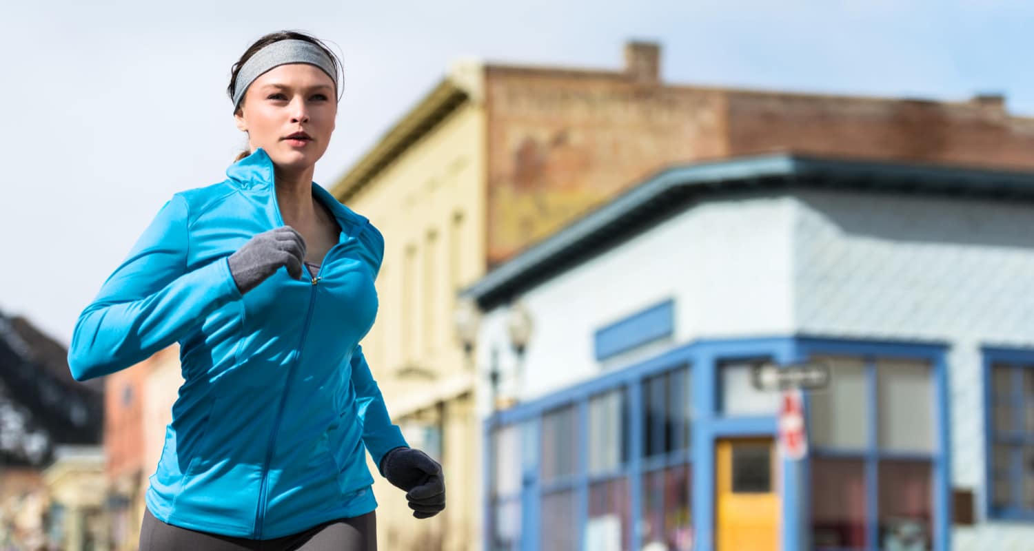Woman running through a downtown area Tapestry Homes in Hickory, North Carolina