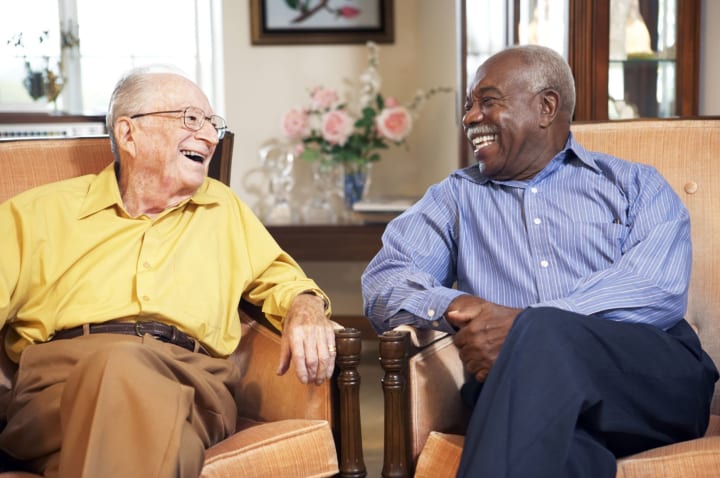 Two senior gentleman laughing together