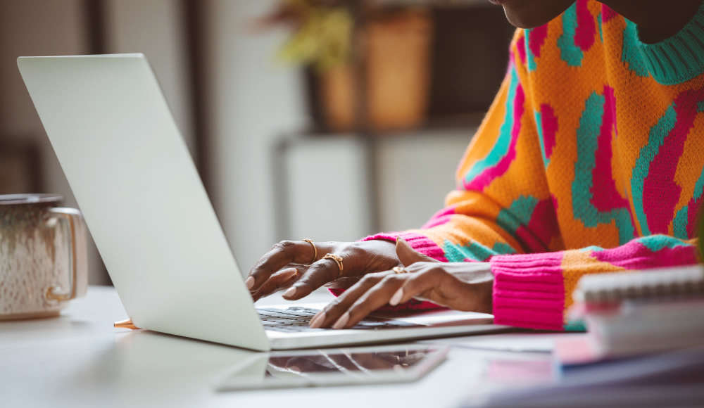 Resident with laptop at Aden Crest in Fort Worth, Texas