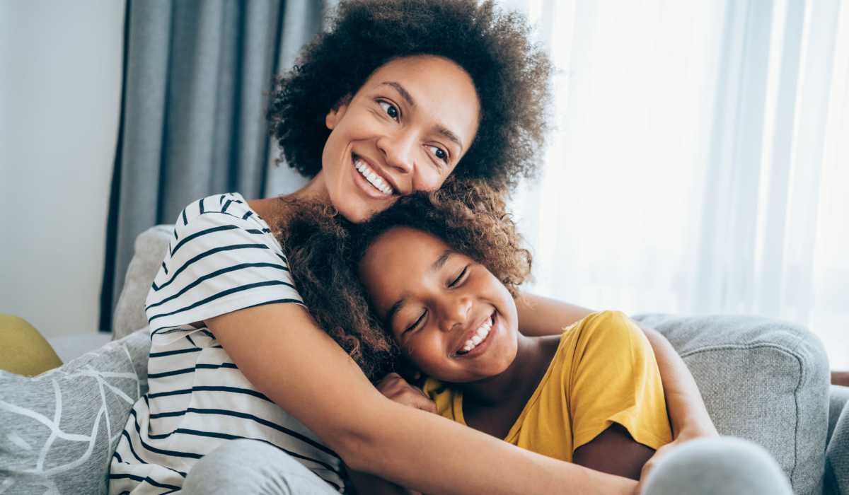 Mother and daughter smiling in their new home at Polo Run Apartments in Stockton, California