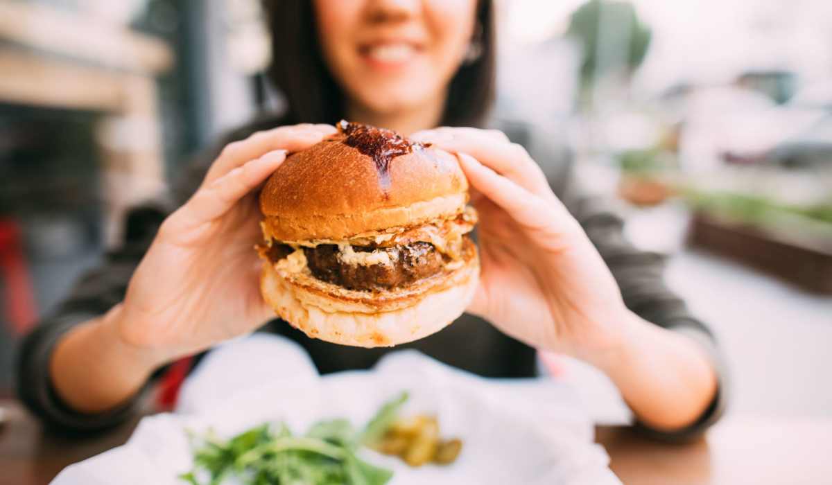 Woman enjoys a hamburger near 1400 Chestnut in Chattanooga, Tennessee