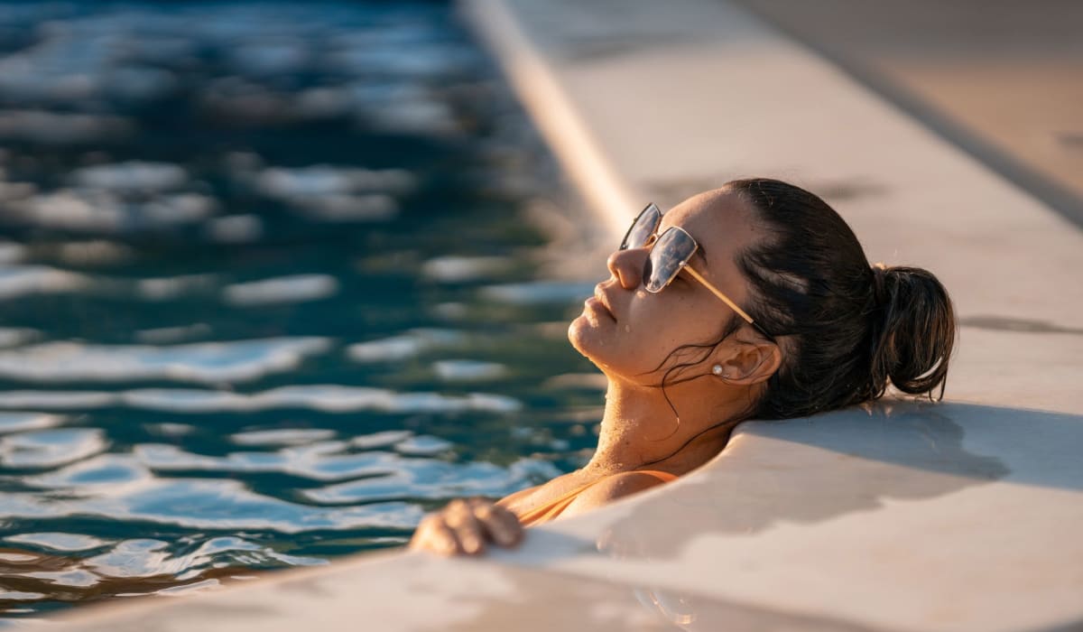 Resident lounging in the pool at Landmark Apartments Phase II in Little Rock, Arkansas