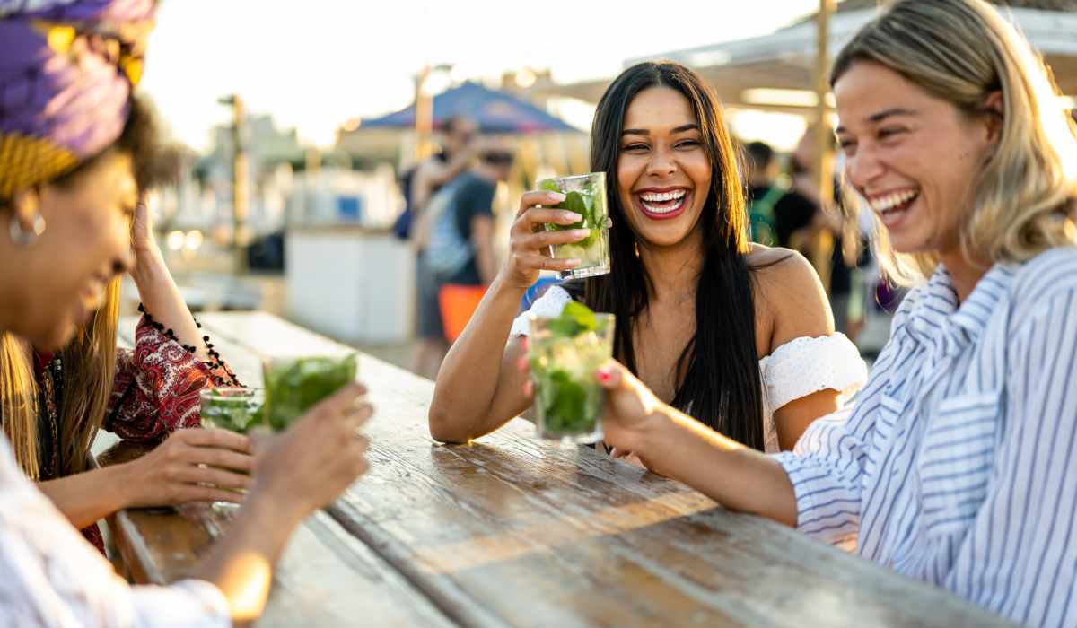 Friends having drinks on a patio near Ventura Park Plaza Apartments in Portland, Oregon