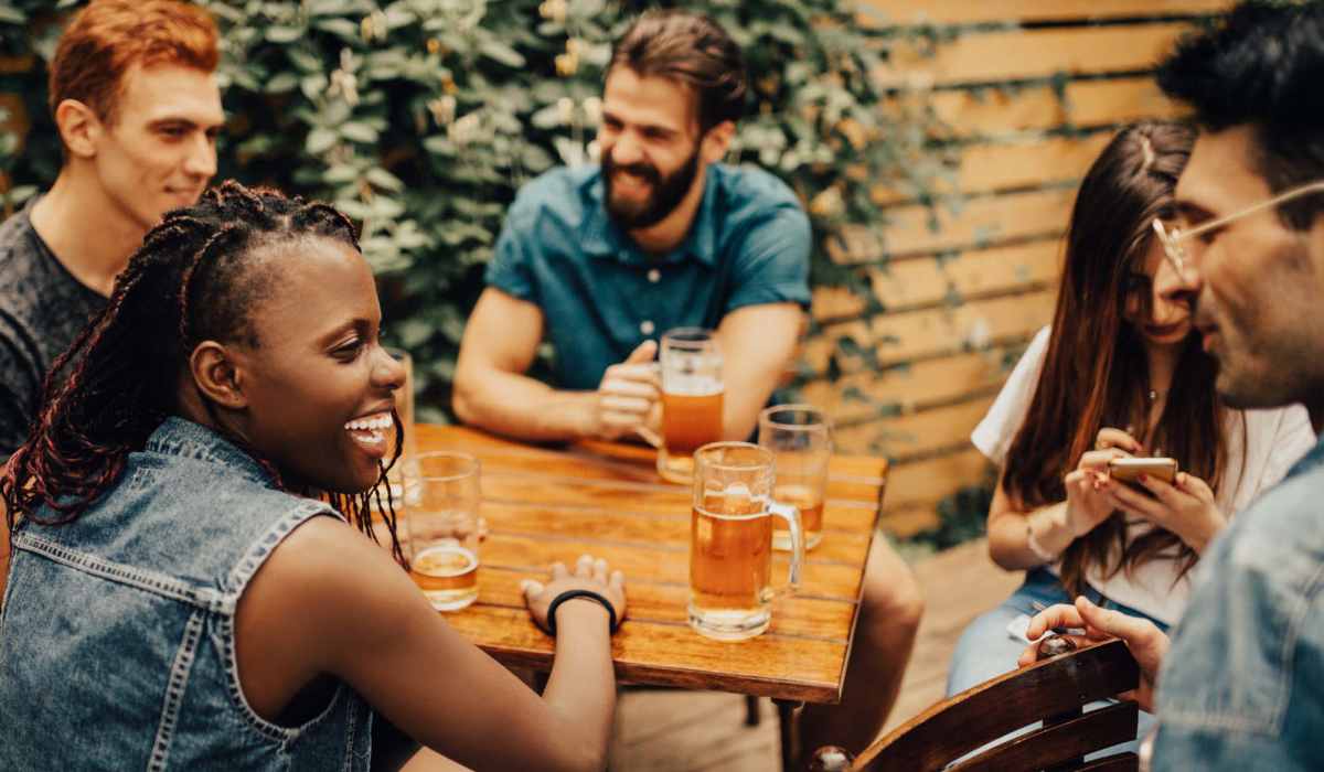 Friends having beers on a patio near Gateway Plaza Apartments in Portland, Oregon