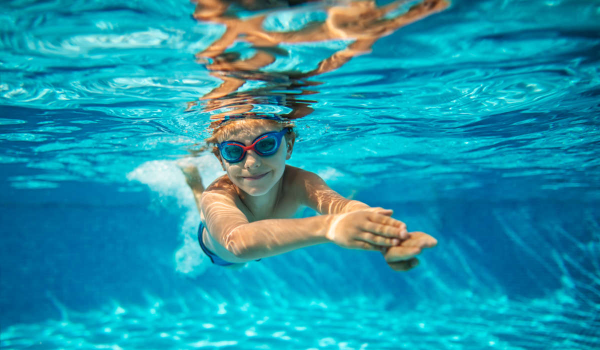 Kid playing in the pool at Millbrook Apartments in Shreveport, Louisiana