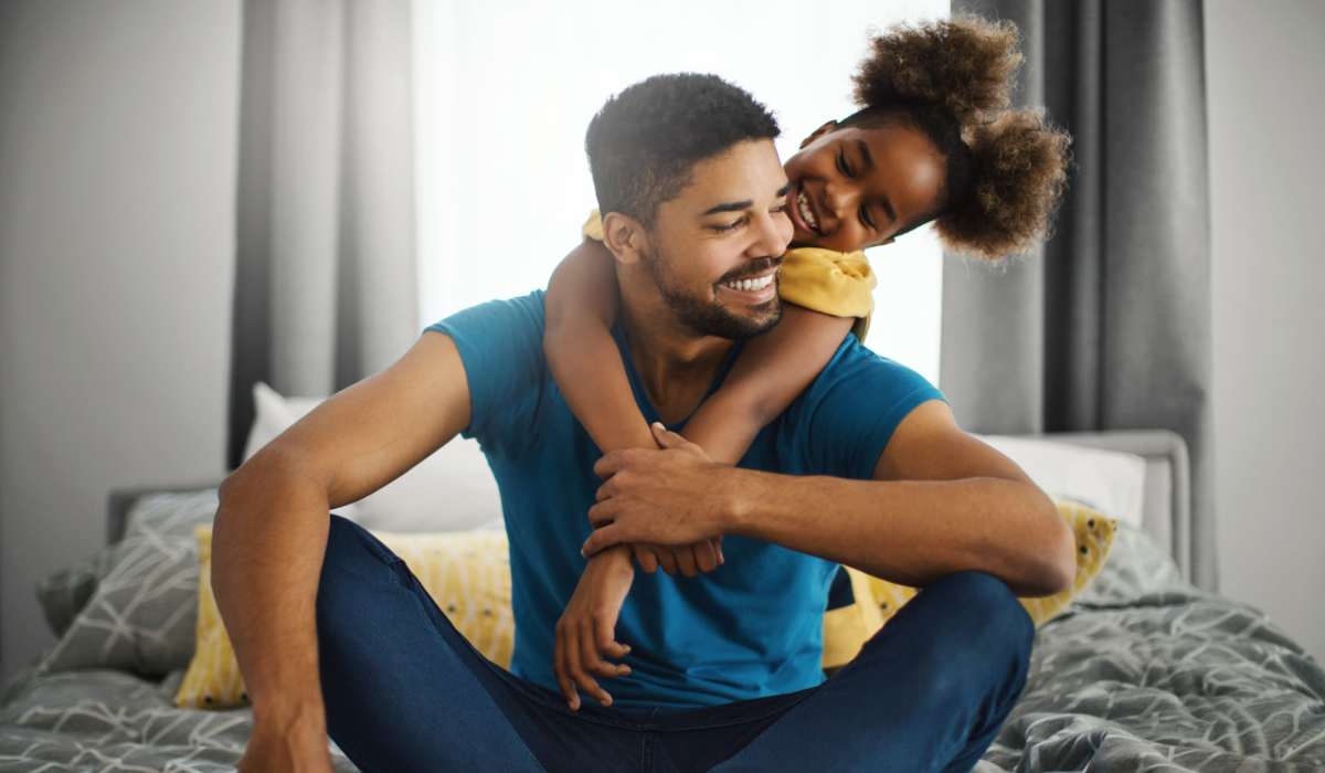 A cute duo of father and daughter in their apartment bedroom at Southwood Village in Shreveport, Louisiana