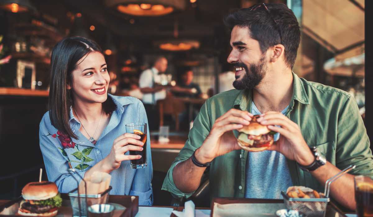 A lovely couple having a burger and fries and having a good time at a restaurant near Prosper 83 in Sparks, Nevada