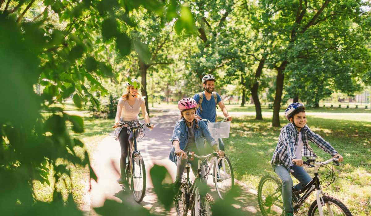 Resident family on bikes at a park near Alaska Apartments in Cincinnati, Ohio