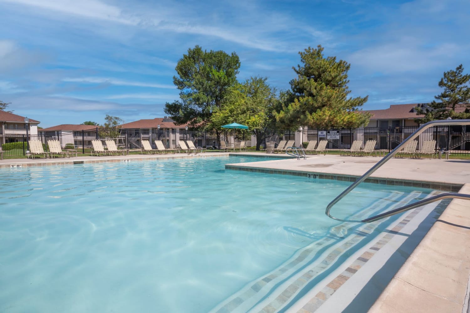 Enjoy having access to a large swimming pool at Wasatch Club Apartments in Midvale, Utah