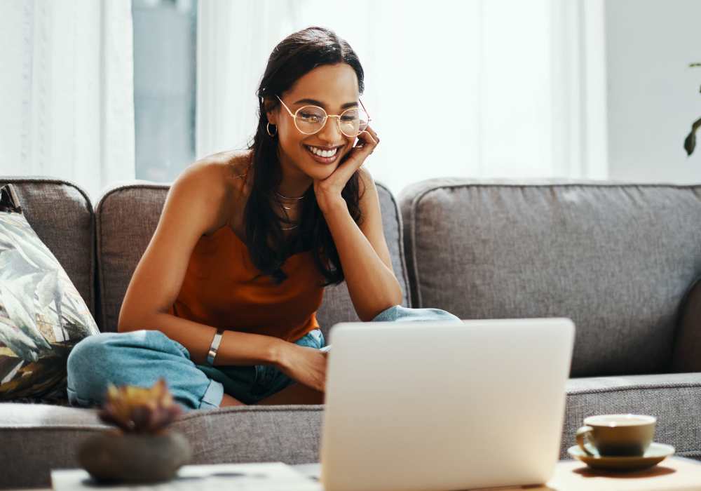 Woman smiling while using laptop at home Redwood in San Marcos, Texas