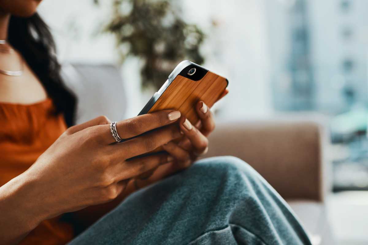 A resident using her phone at Casa Brazoria in Clute, Texas
