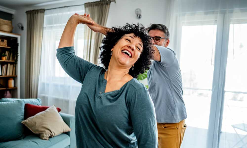 Residents dancing in their home at Sierra Meadows in Humble, Texas