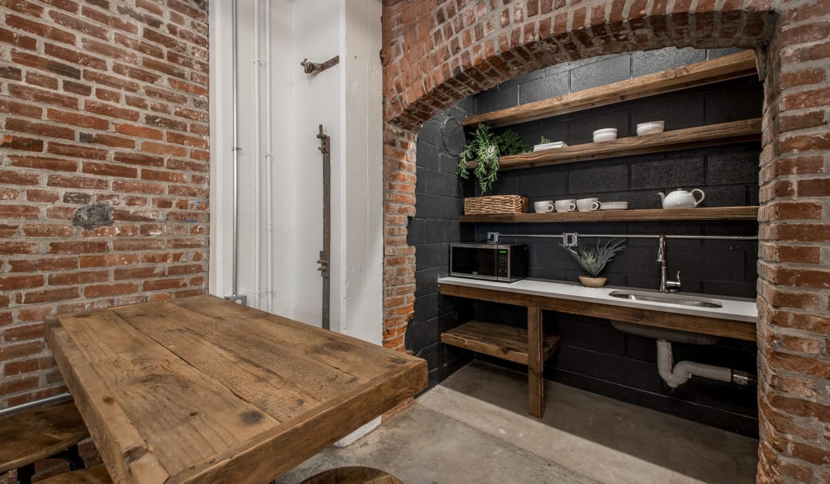 Wooden table with brick wall background at Brush Factory Lofts in Philadelphia, Pennsylvania 