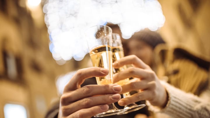 People cheering their champagne together