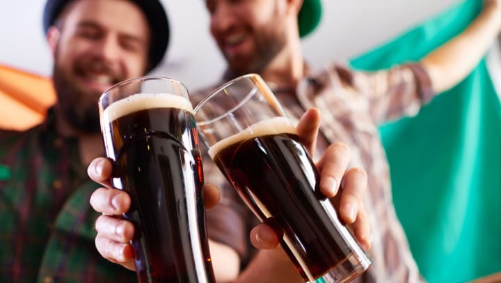 Two men toasting beers