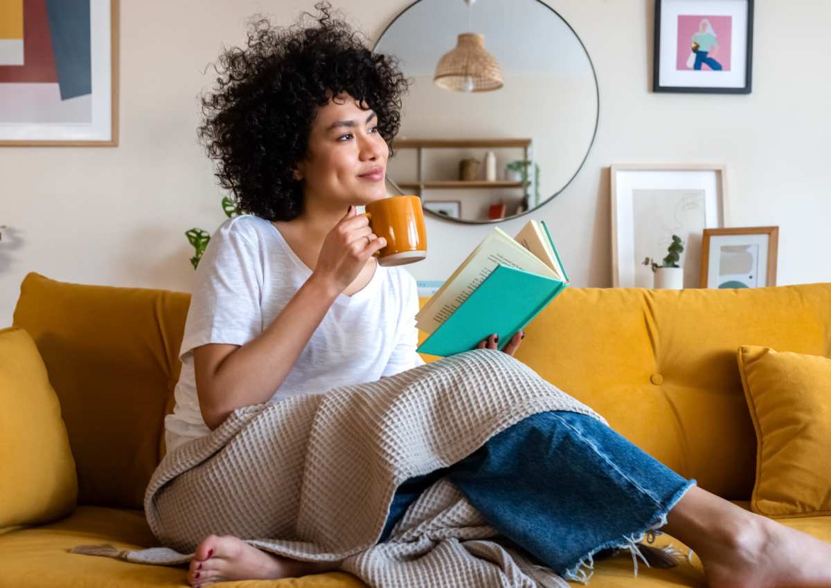 A woman reading a book in a home at The Annex at Bridgeton in Portland, Oregon